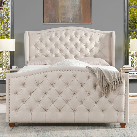 The Marcella Upholstered Shelter Headboard Bed Set features a tufted beige design with high headboard and matching footboard, set in a gray-walled bedroom between two windows and lamps; a gray throw blanket drapes the footboard.