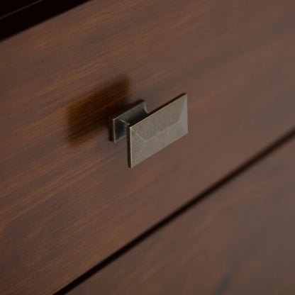 Close-up of the Artisan - Handcrafted, Tall TV Media Stand's wooden drawer, featuring a rectangular metallic handle with a brushed finish and visible wood grain texture.