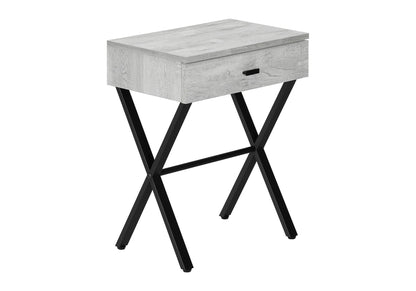 The Accent Side X Table features a contemporary design with a light gray wooden top and storage drawer, supported by black metal X-shaped legs.