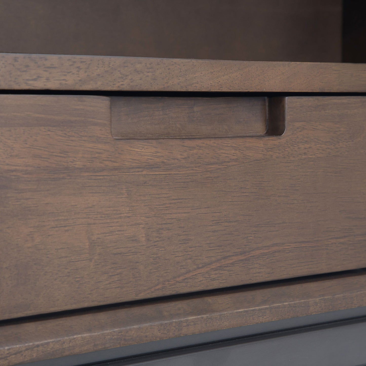 Close-up of a Banting - Mid Century Handcrafted Bookcase drawer with a rectangular cutout handle, highlighting the wood grain and medium brown finish. The partially closed drawer showcases the detailed texture and craftsmanship.