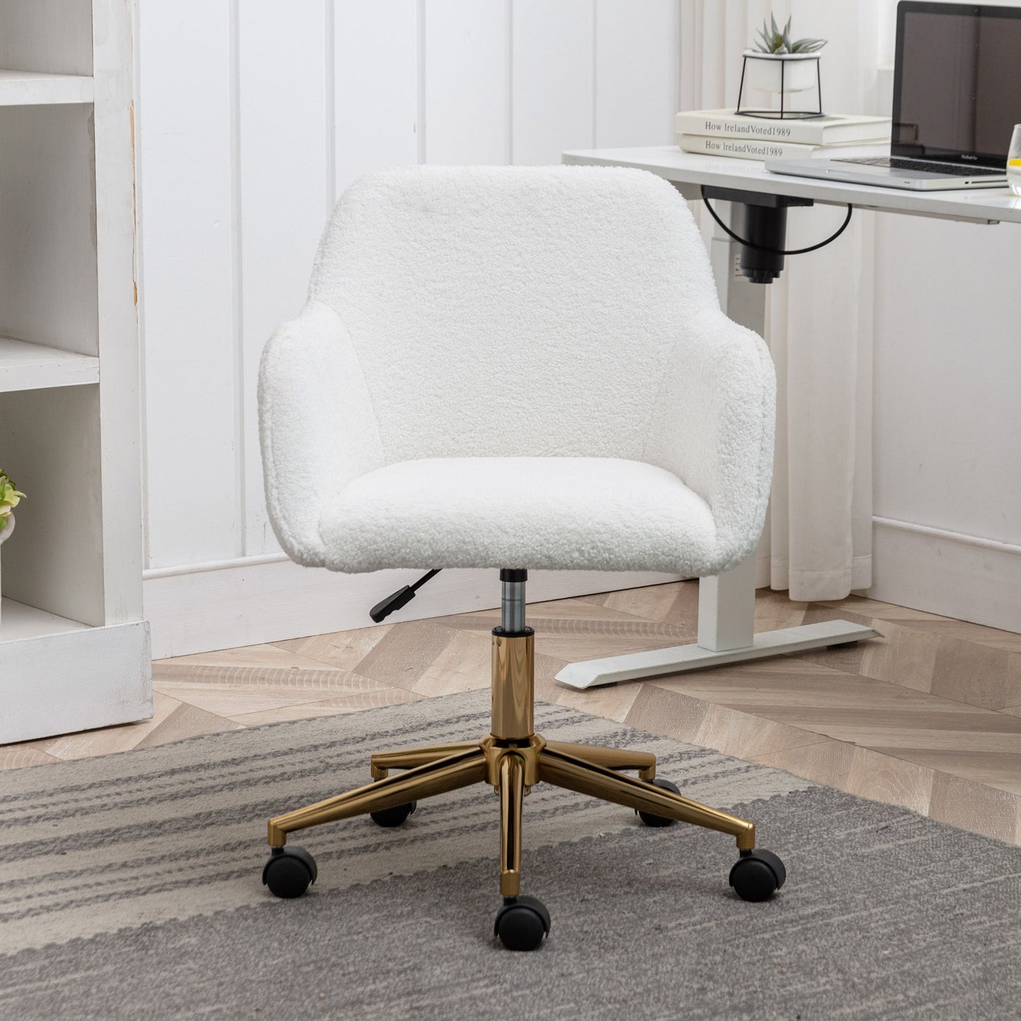 The Modern Adjustable Height 360 Revolving Home Office Chair with metal legs and universal wheels sits on a gray rug in a home office with light wood floors and white furniture.