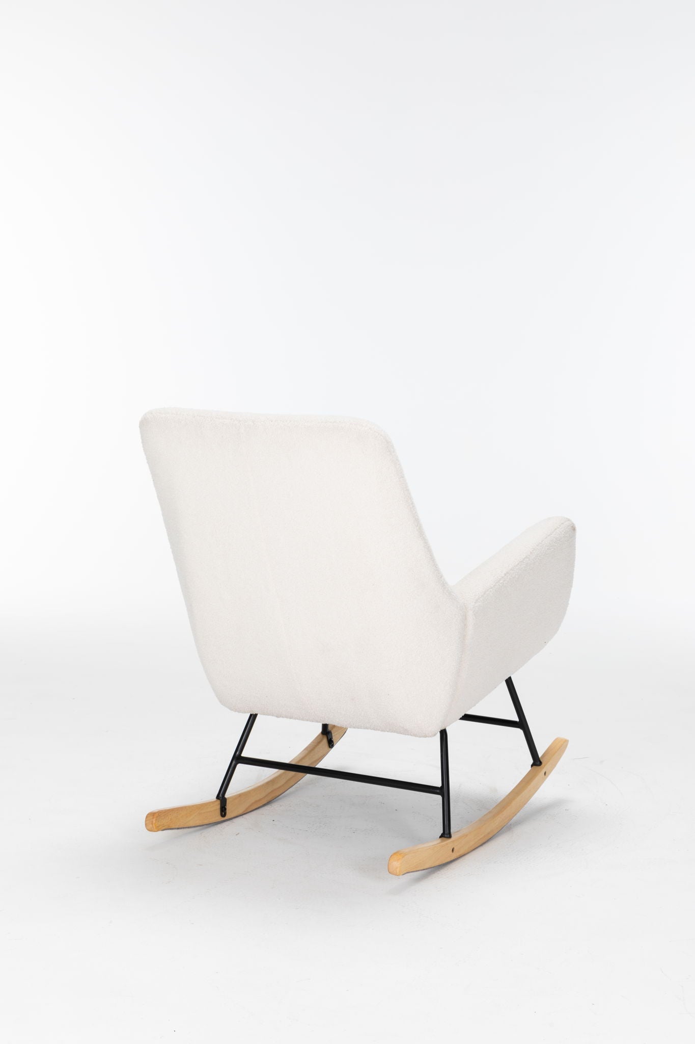 The Rocking Chair Nursery is a cream teddy upholstered glider rocker with a high backrest, cushioned seat, black metal legs, and wooden rockers—perfect as a modern accent chair for living rooms or nurseries.