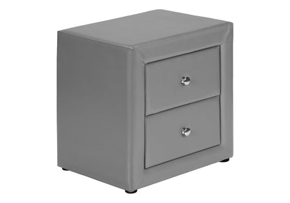 A transitional gray nightstand, upholstered with a faux leather finish, features two storage drawers with round silver knobs. Product: Nightstand, Storage Drawer Versatile Use, Upholstered. Set on a plain white background.