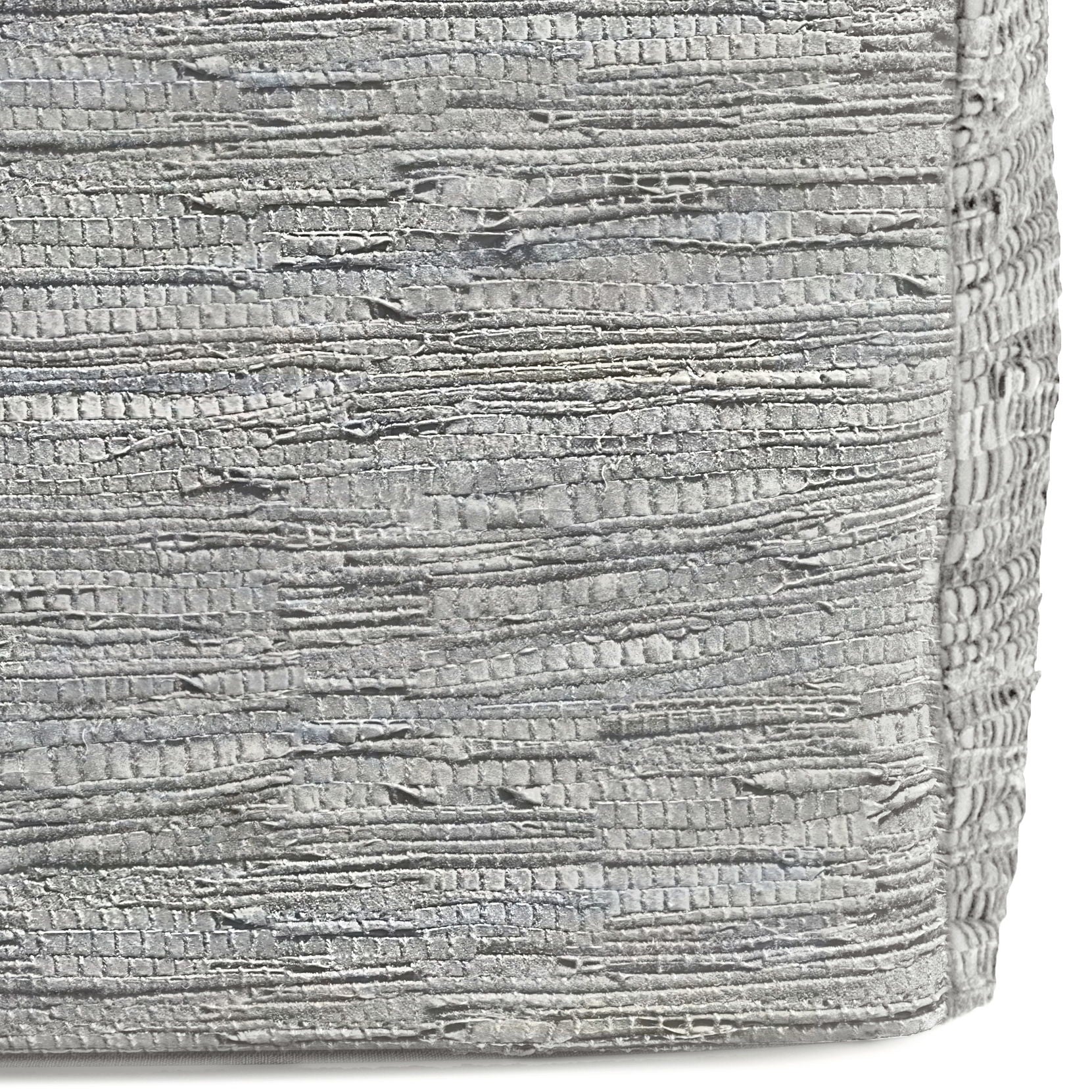 Close-up of the Fredrik - Handcrafted Square Pouf's textured silver fabric, featuring horizontal, irregular ridges and a metallic sheen. The surface is slightly rough and reflective, highlighting its unique artisanal design.