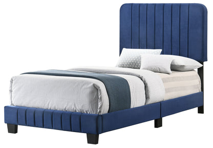 The Lodi - Bed is a twin-size with a tall, vertically paneled blue upholstered headboard and matching frame, styled with striped gray and white bedding, a blue textured blanket, and two pillows.