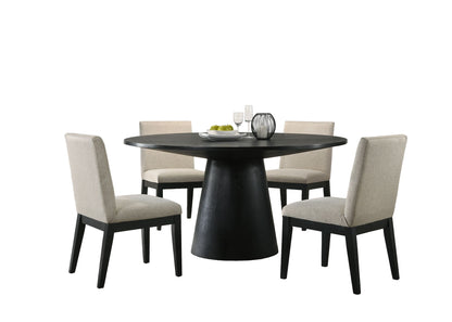 The Jasper Wide Contemporary Round Dining Table Set features a round black table with a wide pedestal base and four beige upholstered chairs, styled with plates, glasses, a bowl of green apples, and vases against a white background.