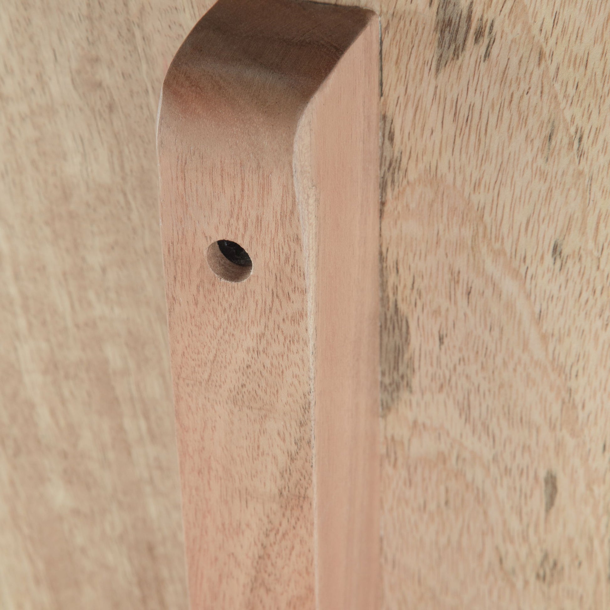 Close-up of the Berkeley - Entryway Bench shows its smooth, light brown wooden plank with a rounded edge and a single drilled hole, attached to a flat wooden surface.