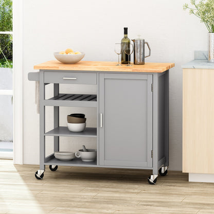 The Contemporary Design Kitchen Cart With Wheels features a gray finish, wooden top, open shelves, and a sliding door. On the counter are glasses, a carafe, and lemons, while bowls and plates are stored on the lower shelves.