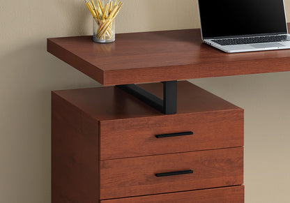 The Computer Desk For Home Office features three storage drawers and a black metal support. On the desk sits a clear cup filled with yellow pencils next to an open laptop.
