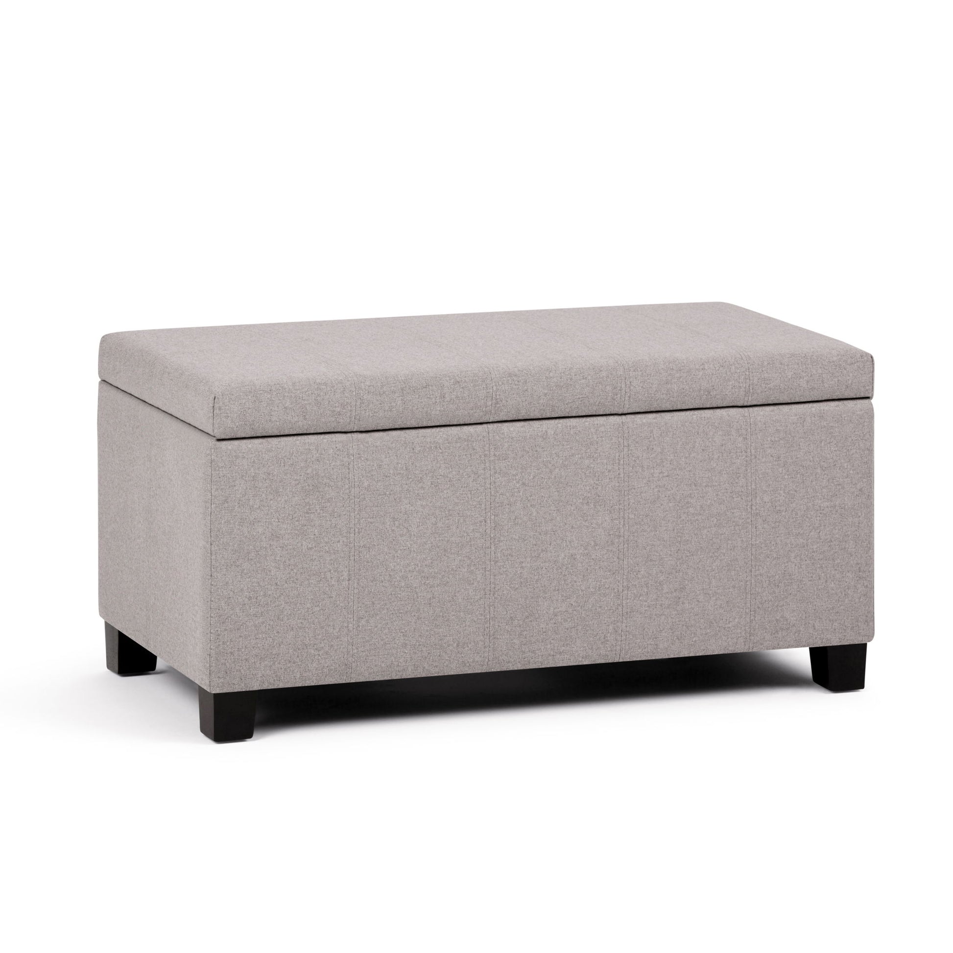 The Dover Upholstered Storage Ottoman Bench features a rectangular design in light gray fabric, a flip-top lid, and short black wooden legs, displayed against a white background.