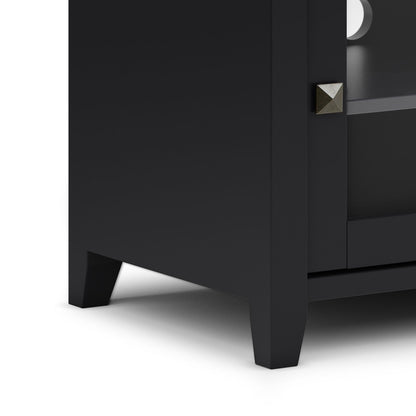 Close-up of the bottom corner of the Cosmopolitan - Handcrafted TV Media Stand, featuring a black finish, square metal knob, and short tapered legs on a white background.