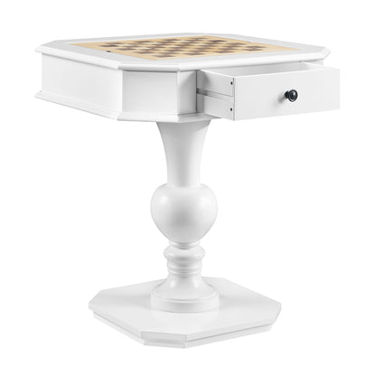 The Galini - Game Table is a small white pedestal table featuring a chessboard top, a partially open single drawer beneath, an ornate round base, and an octagonal bottom platform.
