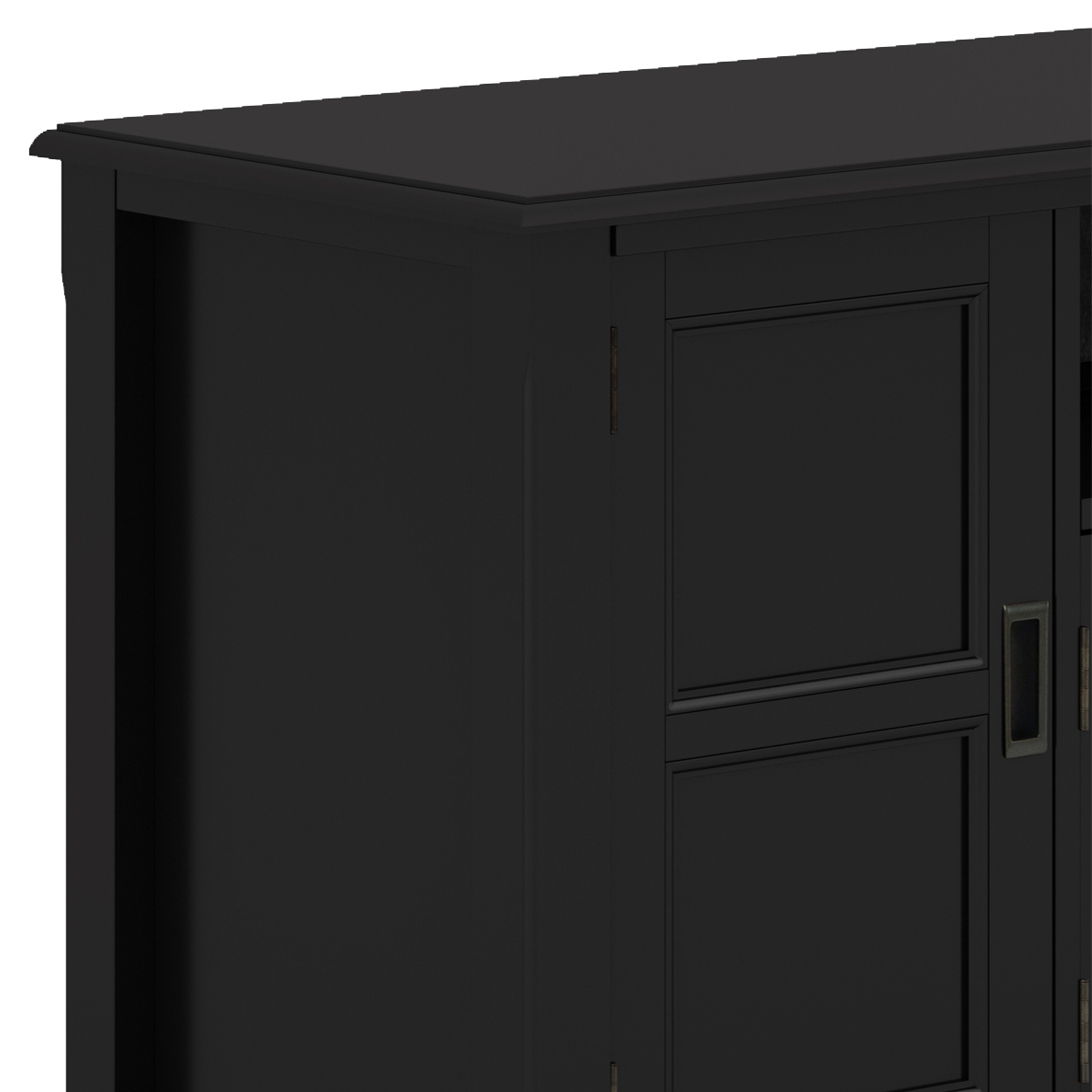 Close-up of the upper left corner of the Burlington - TV Media Stand, featuring black wood with paneled doors and a smooth top surface.
