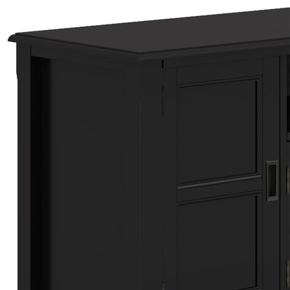 Close-up of the upper left corner of the Burlington - TV Media Stand, featuring black wood with paneled doors and a smooth top surface.