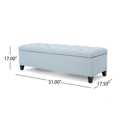 The Glouster Contemporary Storage Ottoman features a light blue upholstered, button-tufted top, black legs, and measures 51"L x 17.5"D x 17"H.
