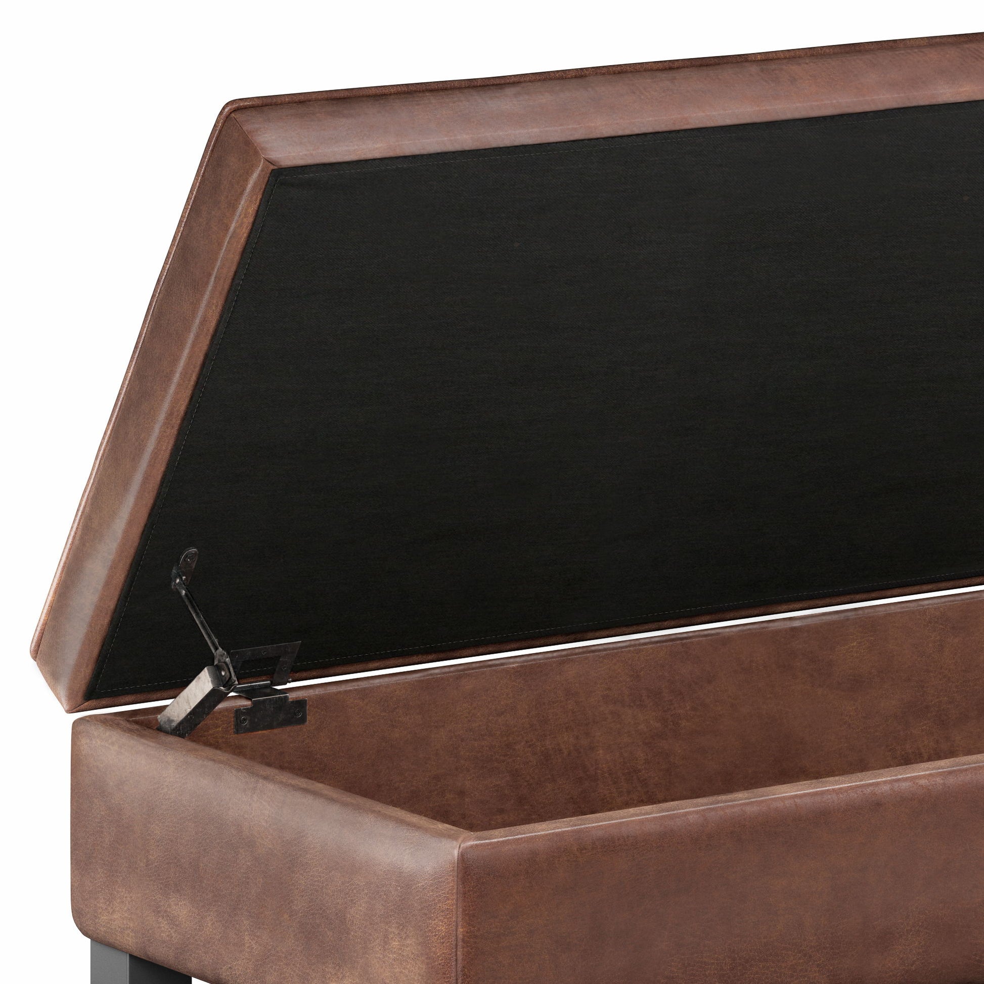 A close-up of the Cosmopolitan Storage Ottoman Bench With Open Bottom features a brown leather exterior and a hinged lid propped open, revealing its spacious black interior compartment.