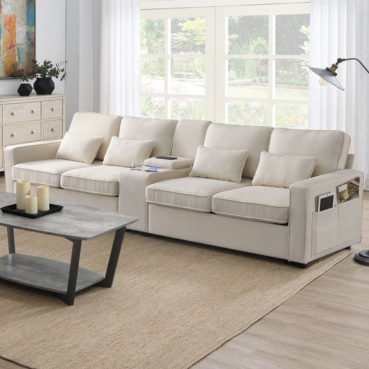 A modern living room features the Upholstered Sofa With Console—an elegant 4-seat linen couch with 4 pillows, built-in cupholders, USB charging ports (wired/wireless), and a cozy setup highlighted by a coffee table on a tan rug near large windows.