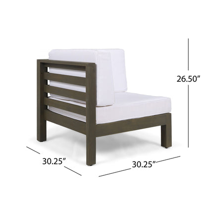 The Oana Arm Chair is a modern outdoor corner chair featuring a dark wooden frame, white cushions, and horizontal slatted side and back panels. It measures 30.25"W x 30.25"D x 26.5"H.