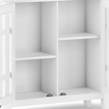 A close-up of the Bedford - Storage Media Cabinet with open doors, revealing two vertical compartments split by horizontal shelves for four storage sections. Features clean lines and metal hinges at the bottom.