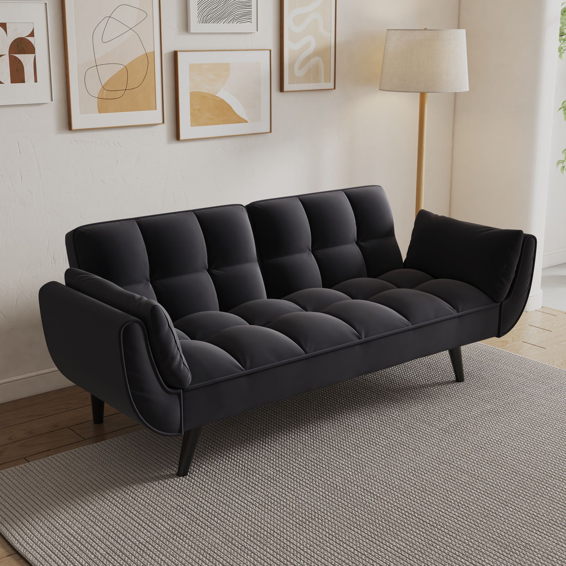 The Sofa Soft with two armrests and cozy pillows sits on a gray rug in a bright living room, decorated with abstract art and a floor lamp, perfect for apartments, bedrooms, or small spaces.