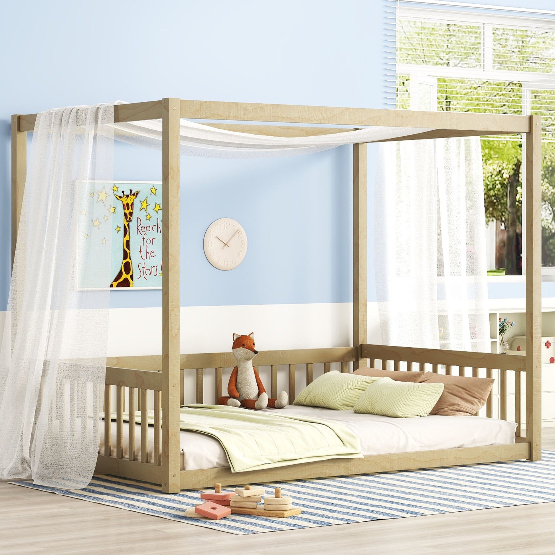 A cozy kids' room featuring the Canopy Frame Floor Bed With Fence, Guardrails, green bedding, sheer white curtains, a plush fox toy, giraffe "Reach for the Stars" wall art, and a large sunlit window.