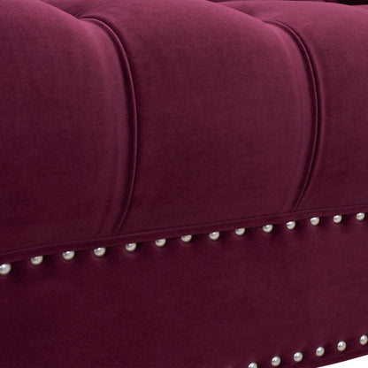 Close-up of the La Rosa - Victorian Chesterfield Tufted Sofa featuring plush deep burgundy upholstery, vertical stitching, and a row of silver decorative studs along the edge.