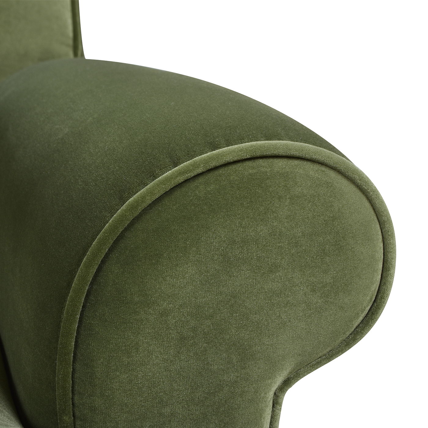 Close-up of the Alana Lawson Three Cushion Tightback Sofa in green upholstery, highlighting its smooth, curved armrest and soft, velvety fabric texture.