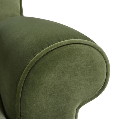 Close-up of the Alana Lawson Three Cushion Tightback Sofa in green upholstery, highlighting its smooth, curved armrest and soft, velvety fabric texture.