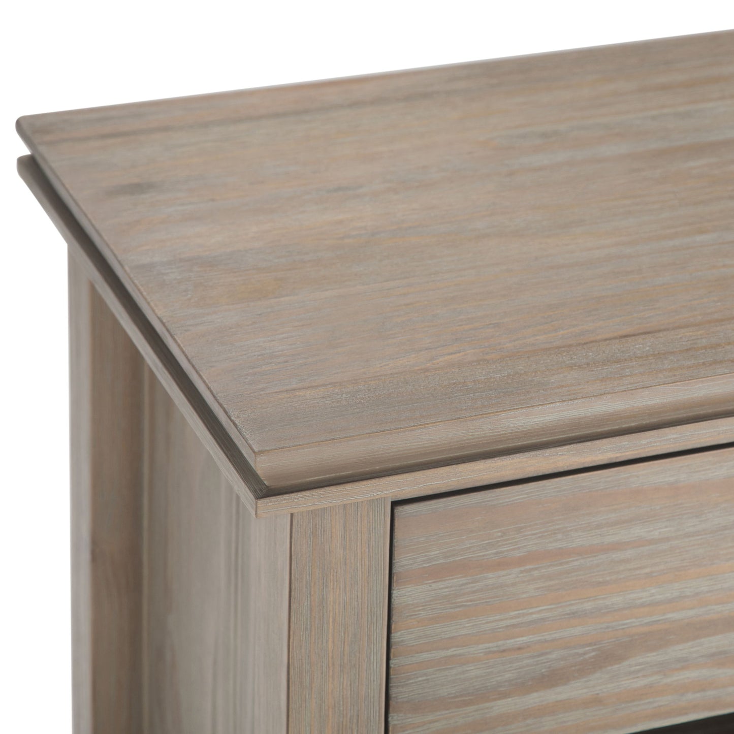 Close-up view of the top corner of the Artisan - Handcrafted Bedside Table, featuring a light, weathered finish and smooth, angled edges.