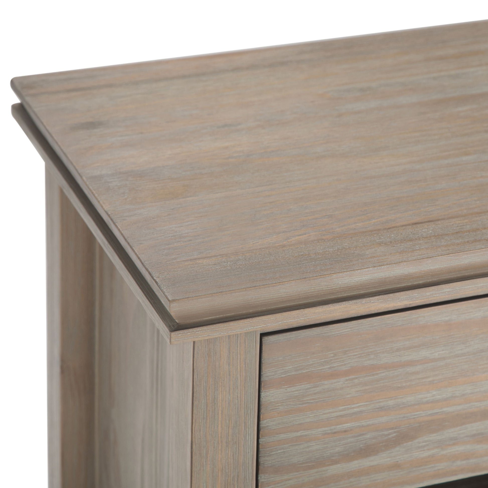 Close-up view of the top corner of the Artisan - Handcrafted Bedside Table, featuring a light, weathered finish and smooth, angled edges.