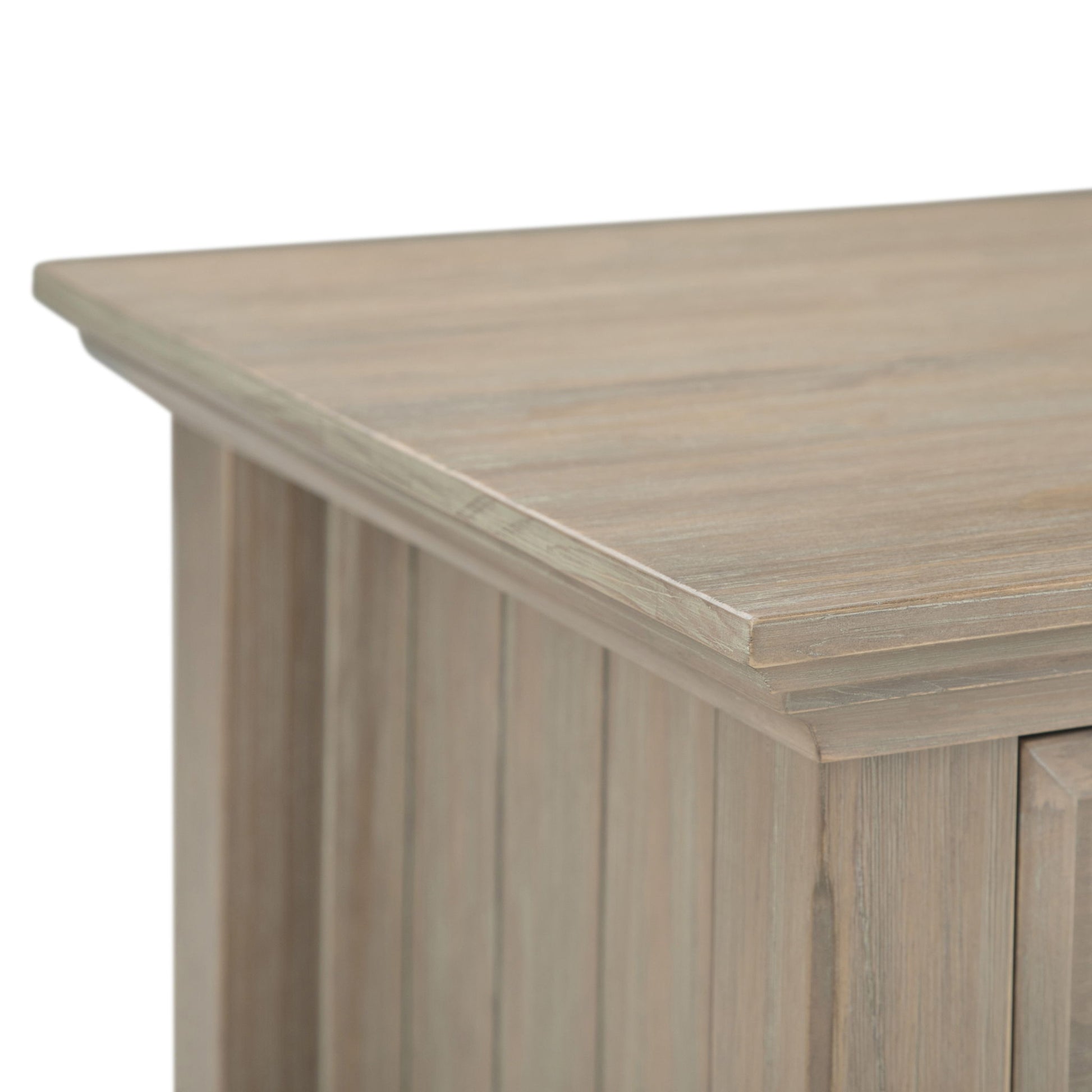 Close-up of the corner of the Acadian - Bedside Table, Handcrafted, showcasing its light natural wood finish, visible grain texture, vertical paneling, and smooth top surface.
