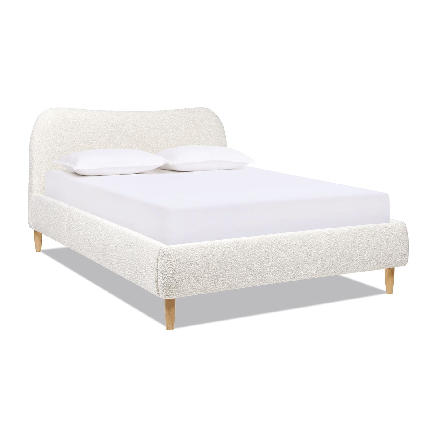 The Roman Curved Headboard Upholstered Platform Bed features a white upholstered frame, curved headboard, light wooden legs, and comes neatly arranged with a white mattress and two white pillows.