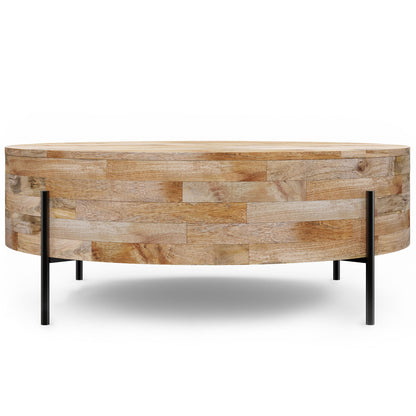 The Rayburn Drum Coffee Table in natural wood features a round design with a light finish and four slim black metal legs, displayed against a white background.