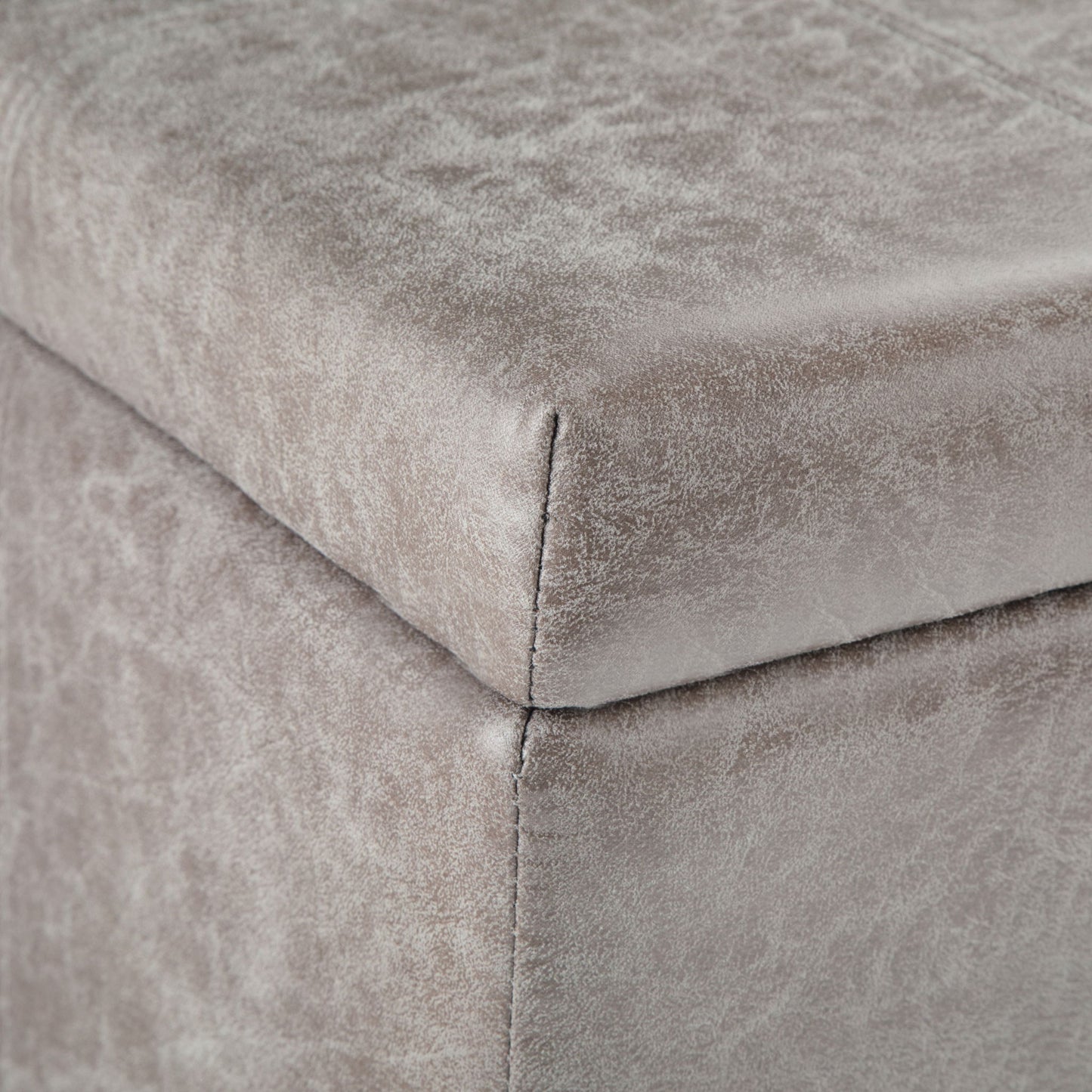 Close-up of the corner of the Dover Upholstered Storage Ottoman Bench, featuring soft gray velvet fabric and visible edge stitching.