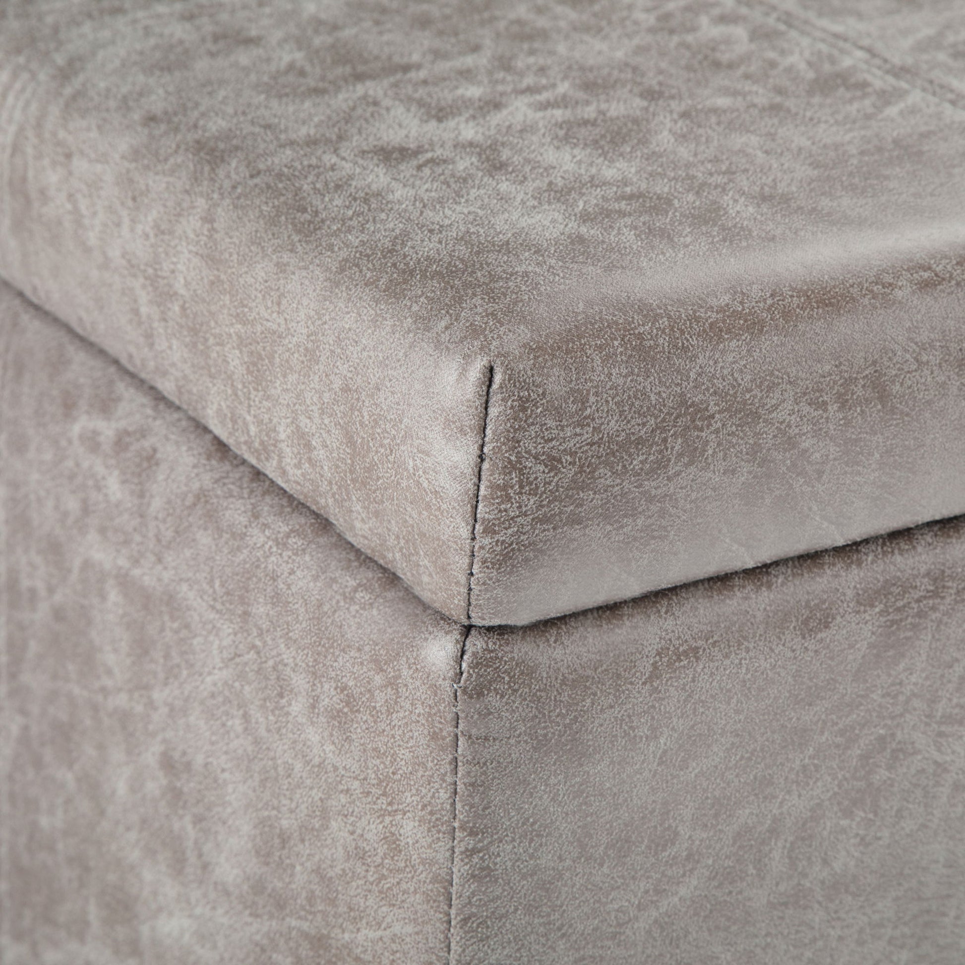 Close-up of the corner of the Dover Upholstered Storage Ottoman Bench, featuring soft gray velvet fabric and visible edge stitching.