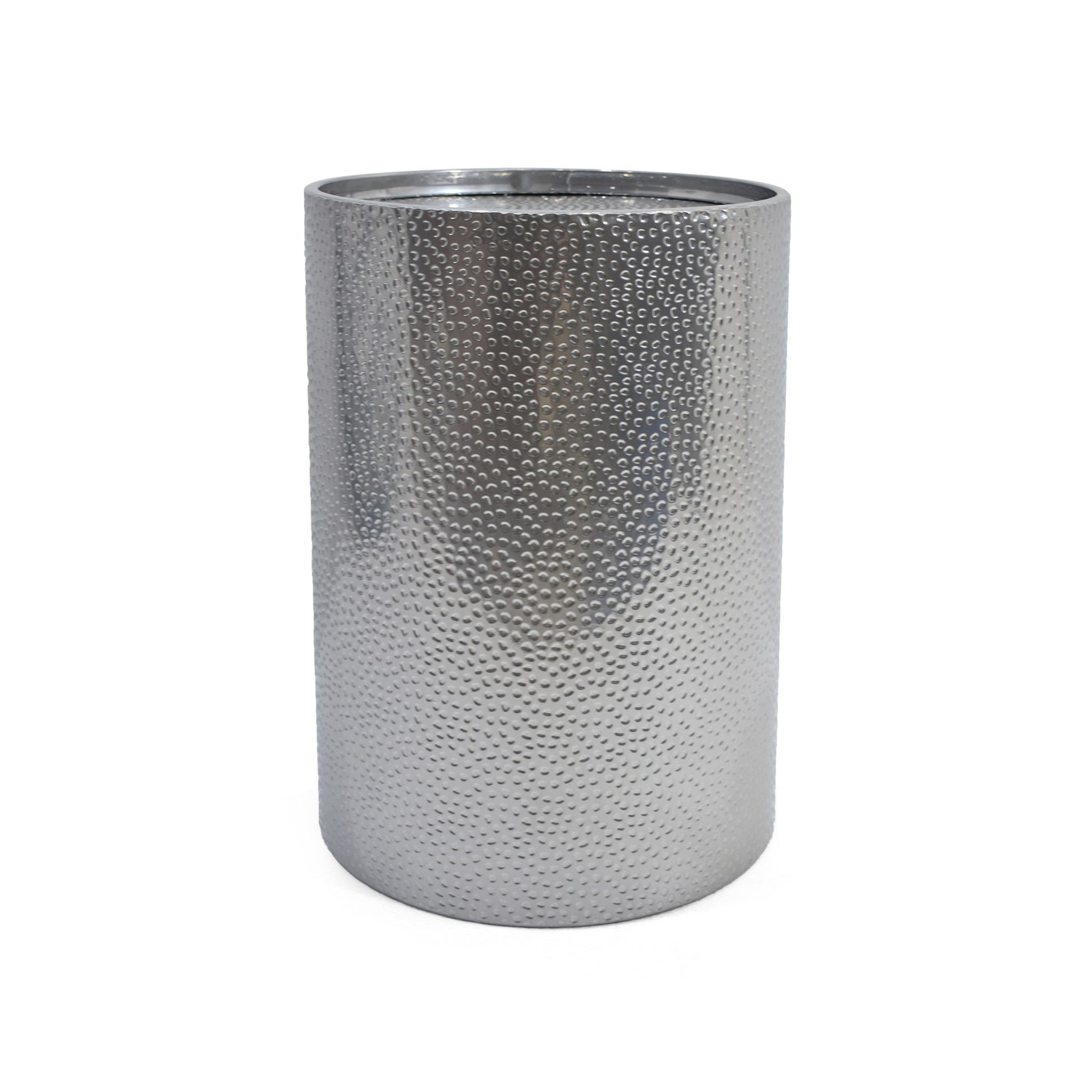 A modern round accent table with a hammered silver metal surface and cylindrical shape, shown against a plain white background.