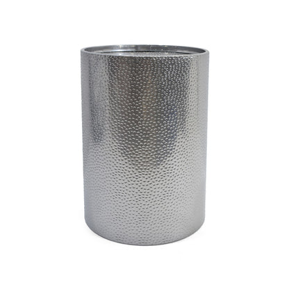 A modern round accent table with a hammered silver metal surface and cylindrical shape, shown against a plain white background.