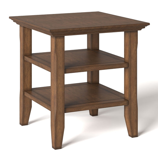 The Acadian - Transitional End Table features a square top, two open lower shelves, four tapered legs, and a medium brown wood grain finish.