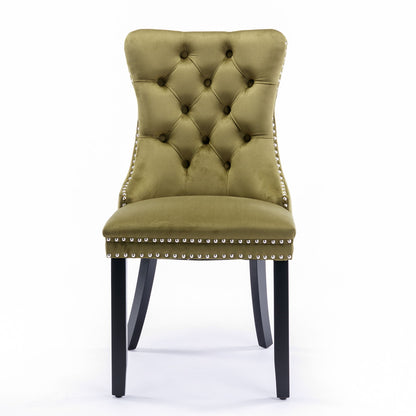 The Nikki set features modern high-end tufted olive green velvet dining chairs with dark wood legs and silver nailhead trim, photographed against a plain white background.