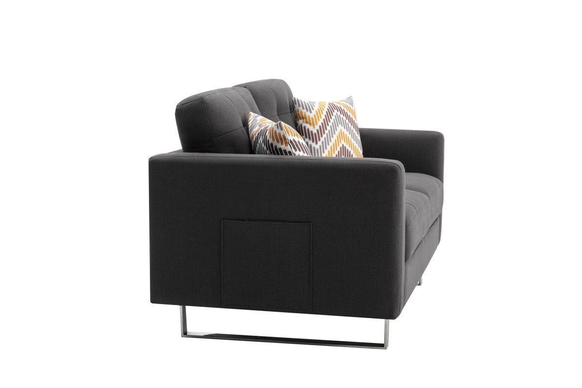 The Victoria loveseat features linen fabric in dark gray with metal legs, side pockets, and two geometric-patterned throw pillows in yellow, gray, and white tones, shown against a plain white background.