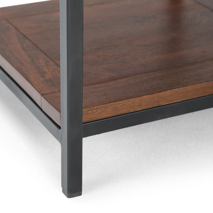 Close-up of the corner of the Skyler - Handcrafted Table, featuring a dark metal frame and wooden shelf, shown against a white background.