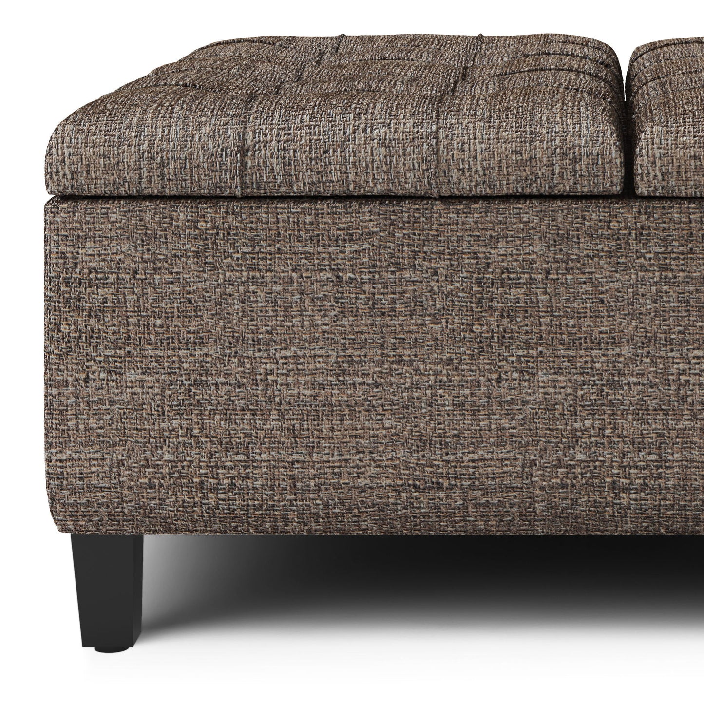 Close-up of the Harrison Upholstered Coffee Table Storage Ottoman, featuring textured brown fabric, a rectangular shape, black wooden legs, and a lid slightly raised to reveal storage space.