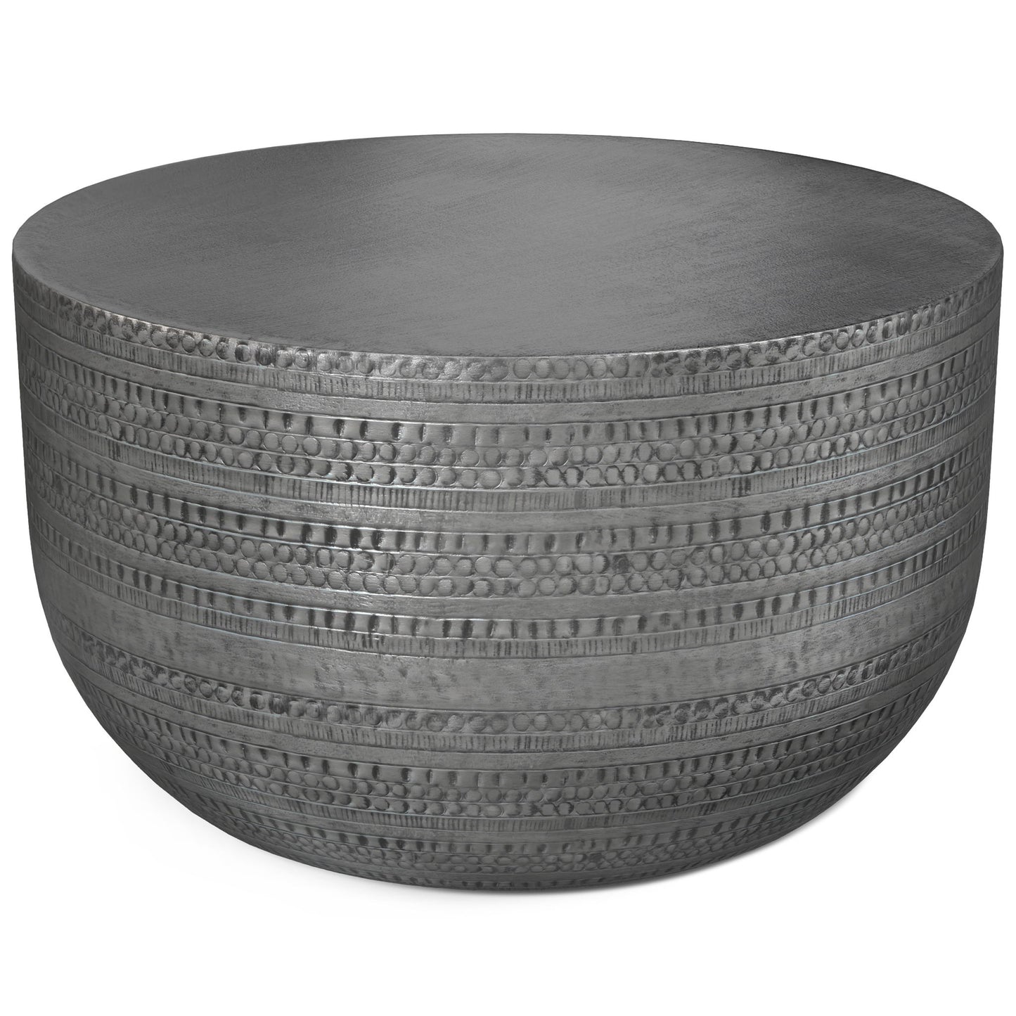 The Johnsen Handcrafted Metal Coffee Table features a round, flat top and textured sides with horizontal lines and circular indentations.