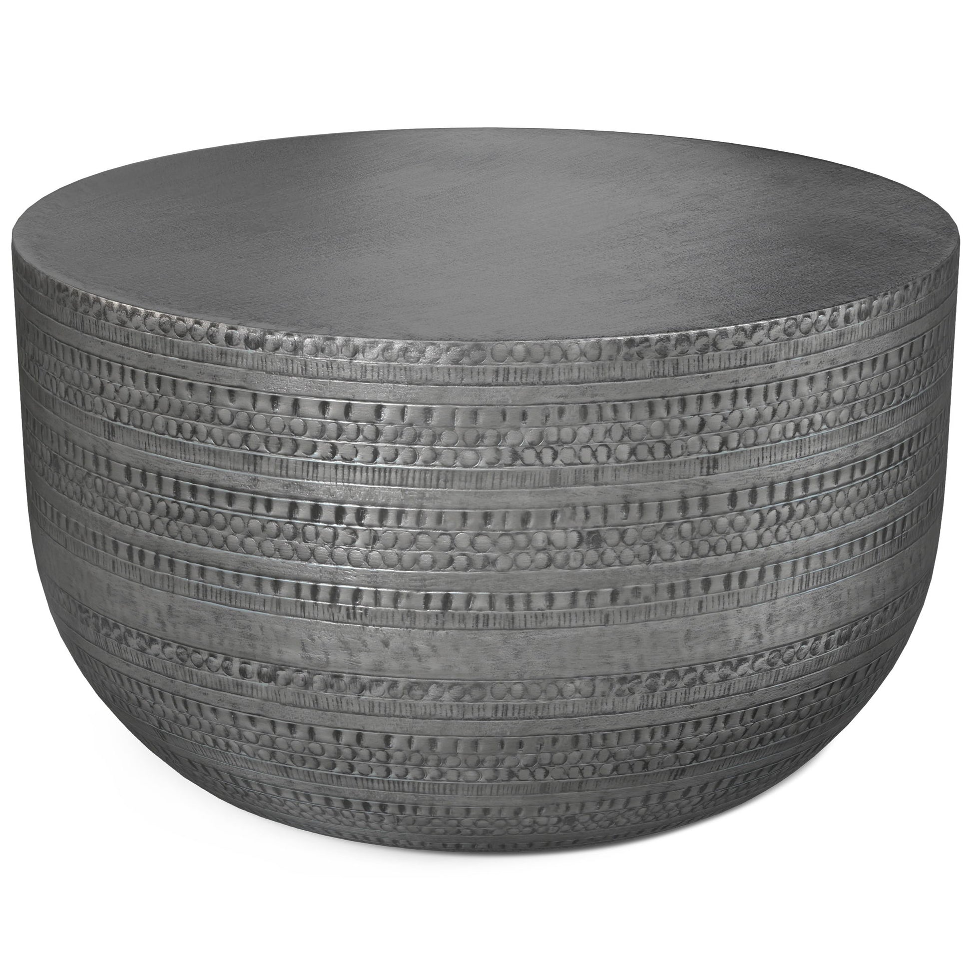 The Johnsen Handcrafted Metal Coffee Table features a round, flat top and textured sides with horizontal lines and circular indentations.