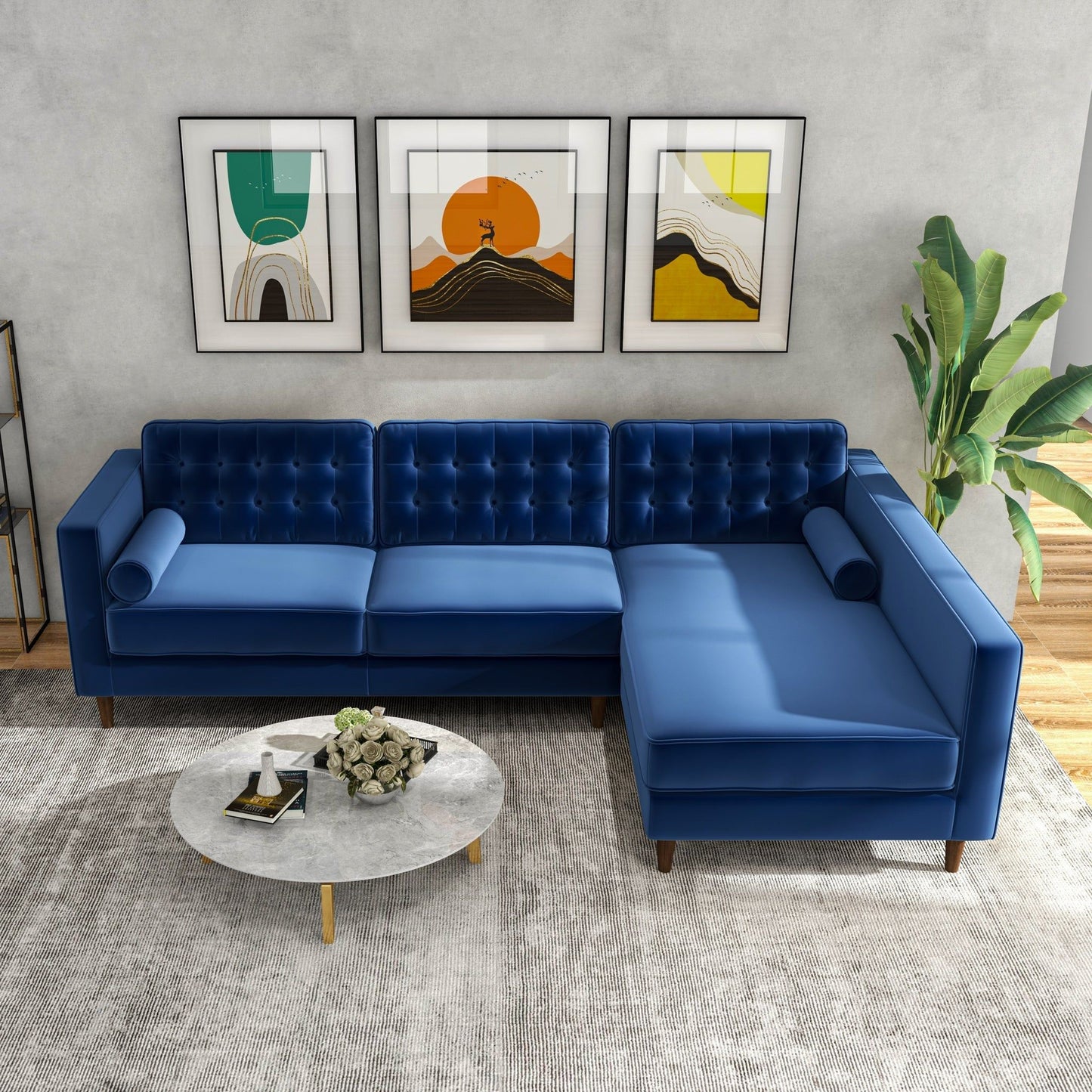 A modern living room featuring the Christian Mid-Century Modern Design Sectional Sofa in blue, a round marble coffee table, abstract wall art, a tall green plant, and a light-colored area rug.