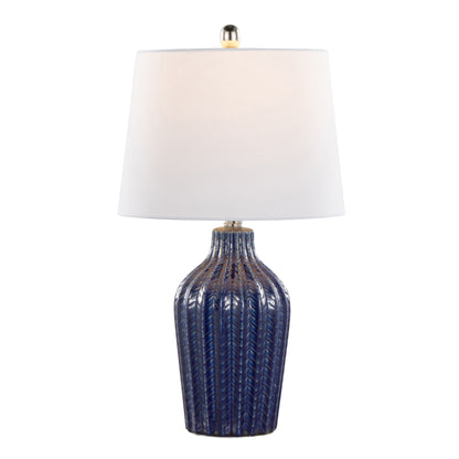 The Rockwell - Contemporary Table Lamp (Set of 2) features a textured dark blue ceramic base, white slightly tapered fabric shade, and a metallic finial on top.