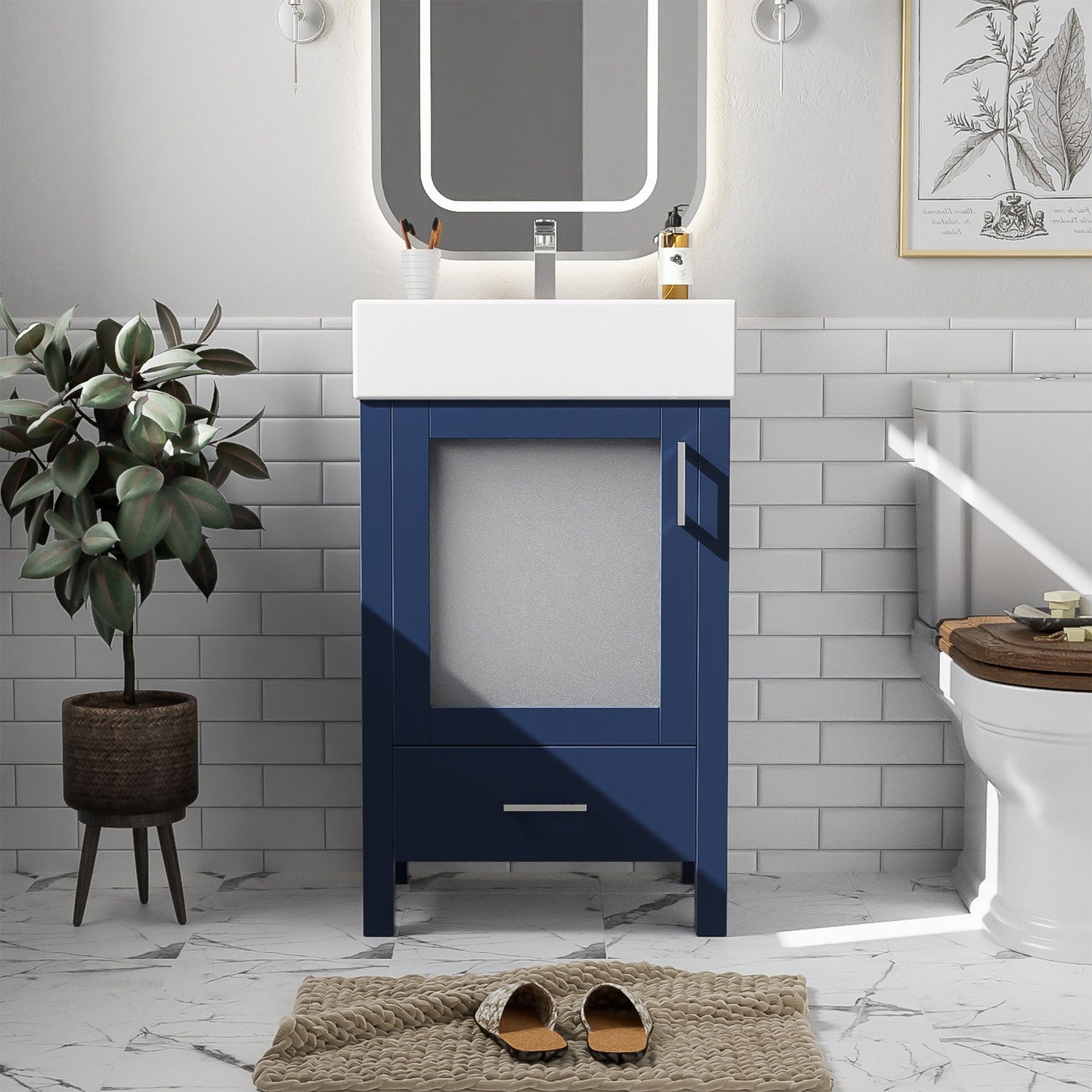 A modern bathroom features the Bathroom Vanity With Ceramic Sink And Ample Storage, Ideal For Small Bathrooms in blue beneath a white sink, with a square mirror above, potted plant on the left, tile walls, toilet with wooden lid on right, and brown slippers on a rug.
