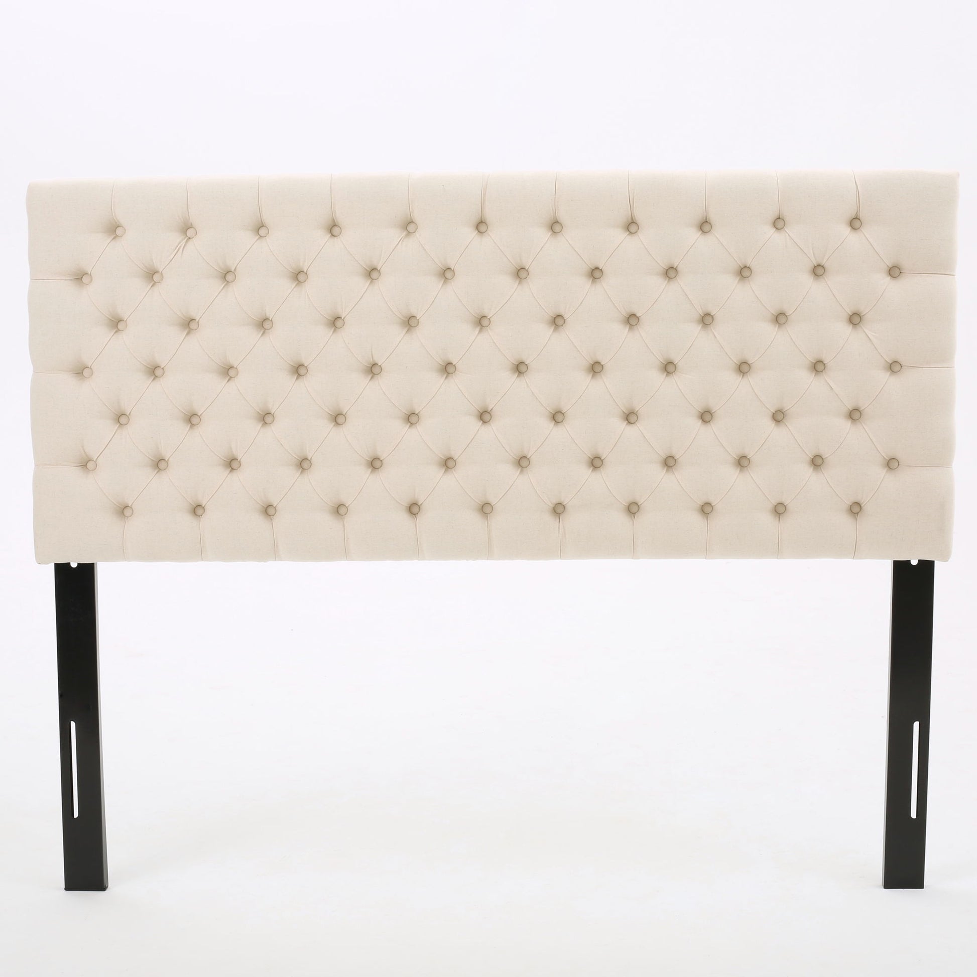 The Annecy - Contemporary Upholstered Headboard features beige tufted upholstery with button detailing and black wooden legs, displayed against a plain white background.