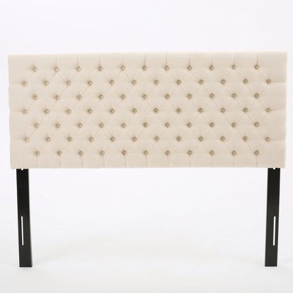 The Annecy - Contemporary Upholstered Headboard features beige tufted upholstery with button detailing and black wooden legs, displayed against a plain white background.