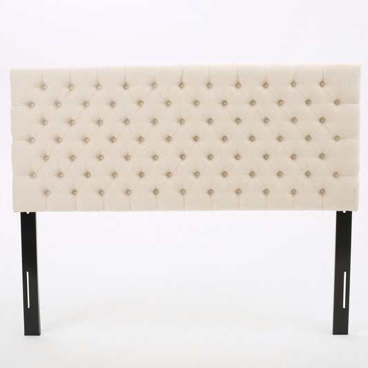 The Annecy - Contemporary Upholstered Headboard features beige tufted upholstery with button detailing and black wooden legs, displayed against a plain white background.